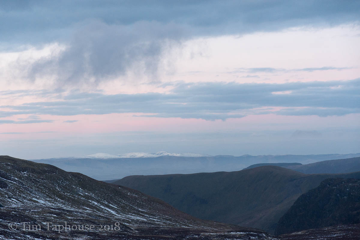 A hint of pink, with snow on distant hills