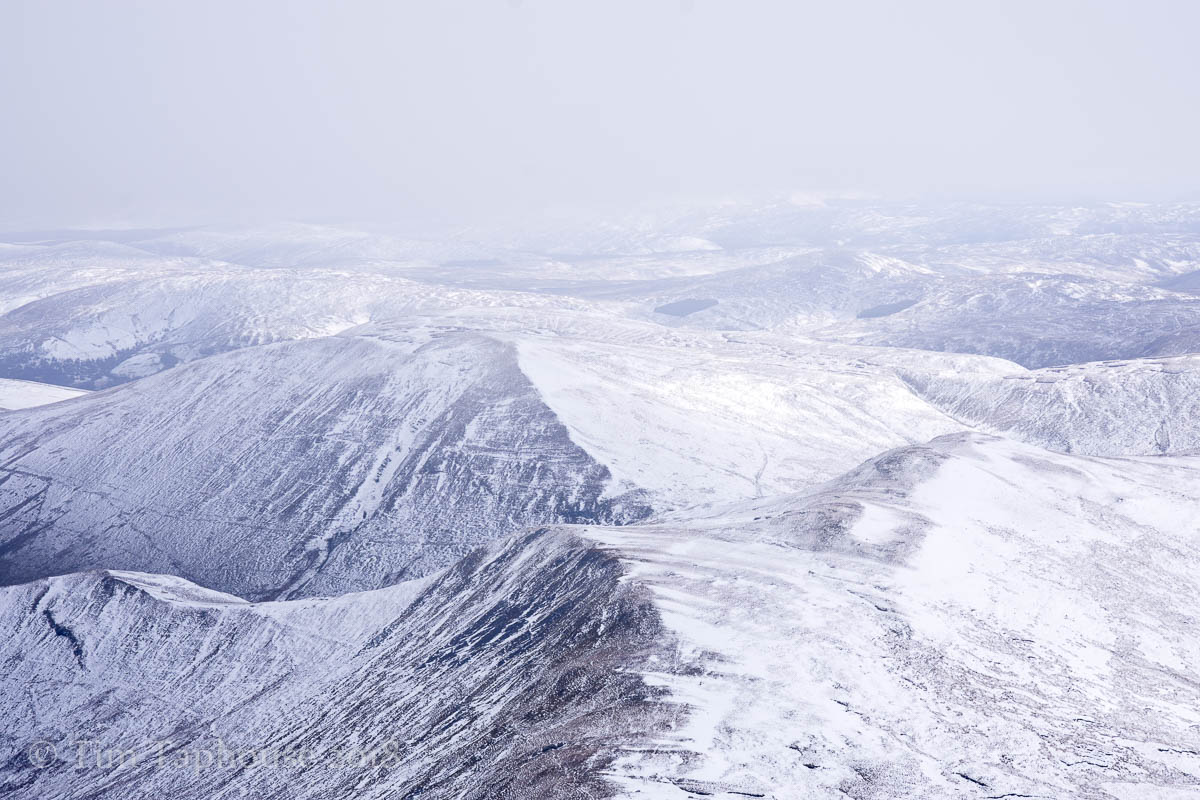 Layers of snowy hills from Aran Fawddwy